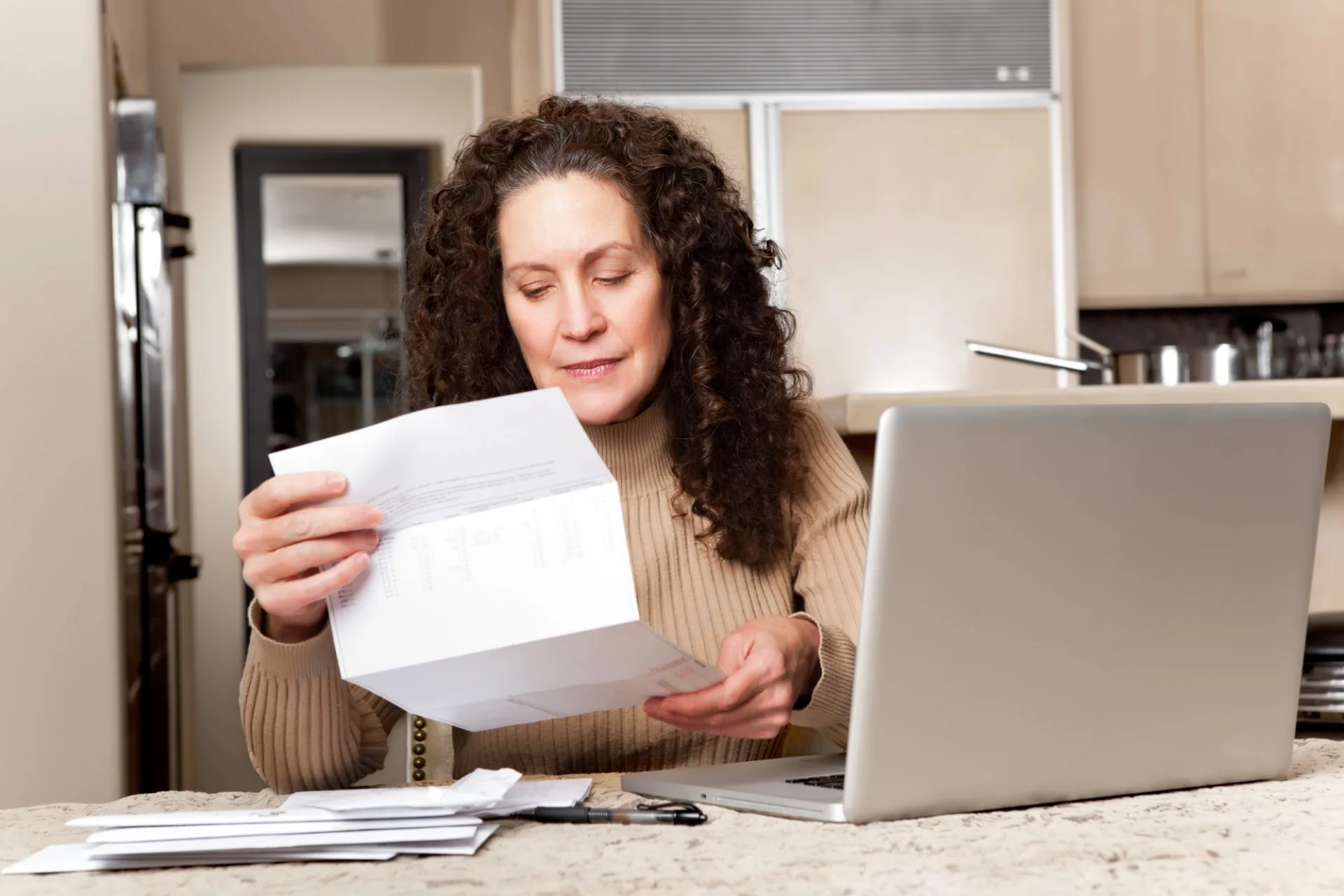 Person reviewing financial statements and legal documents related to a court-appointed trustee during a legal consultation.