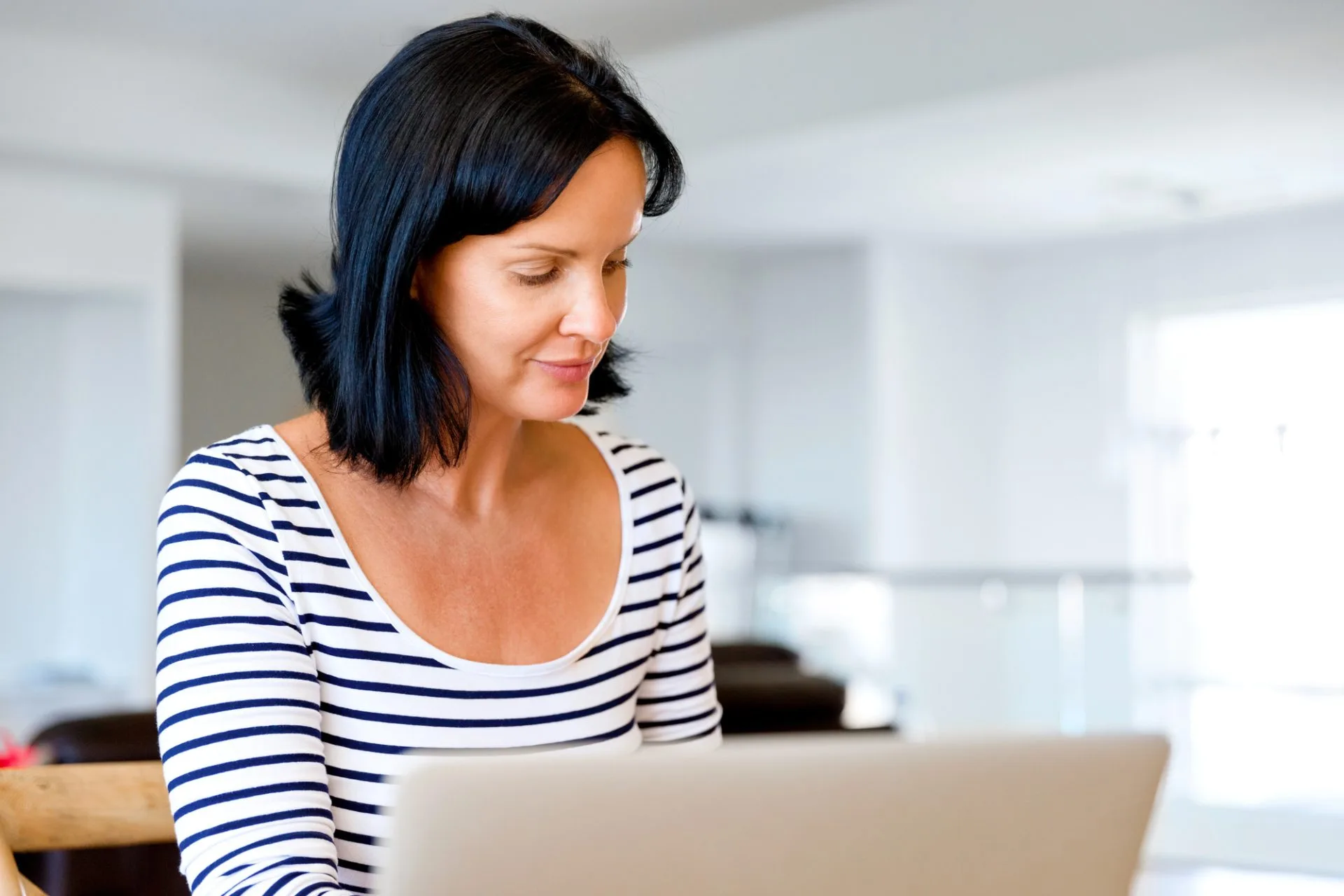 Person reviewing property or financial documents related to suspicious transfers or beneficiary designations during a legal consultation.
